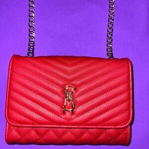 Brand New, Quilted, Red STEVE Madden crossbody/ fold over bag with a gold chain.